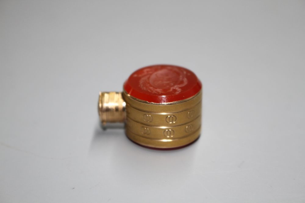 A small 19th century engraved gold and carnelian set moon shaped scent flask,